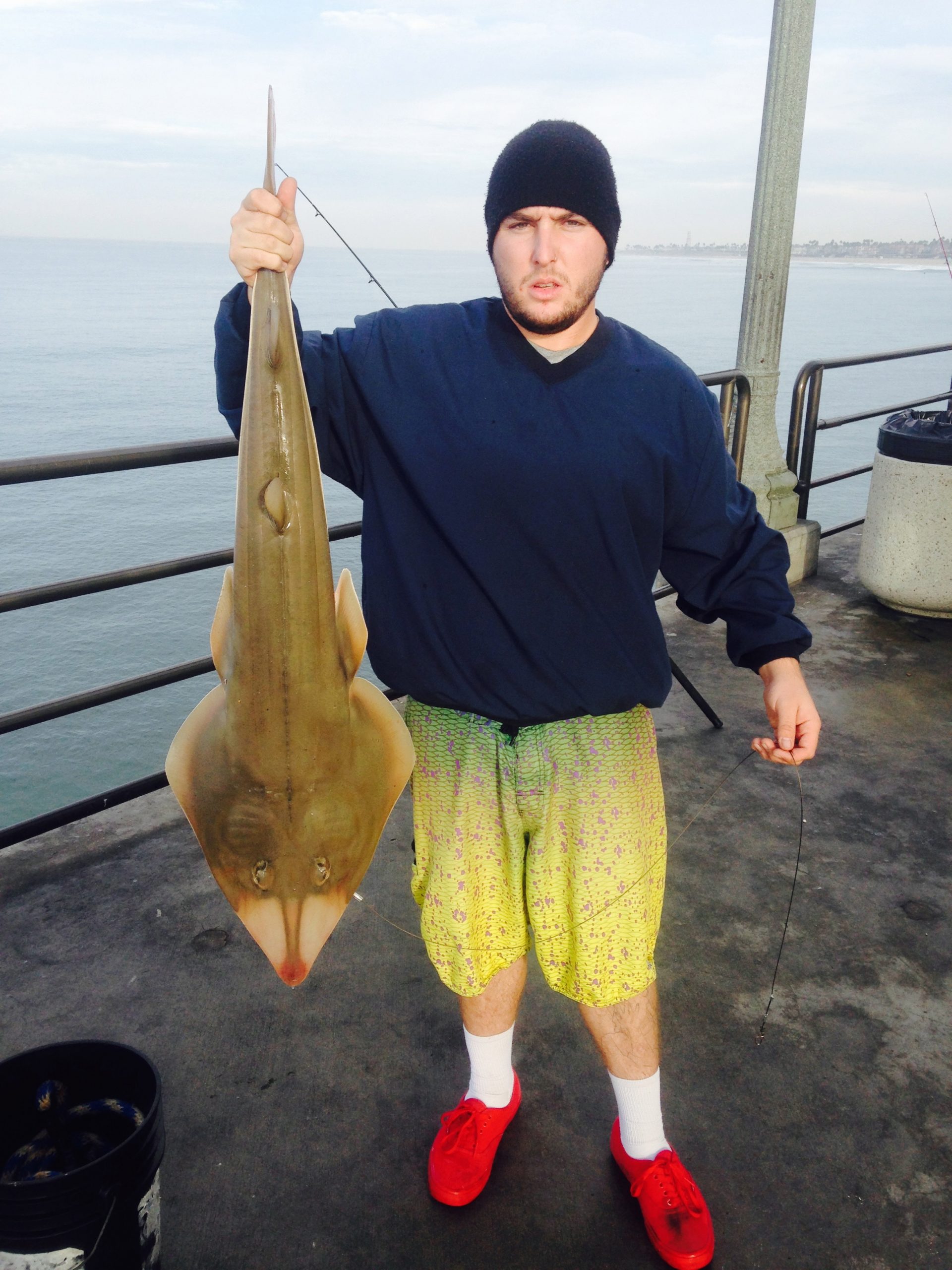 Single surf fishing pole in a pole holder on a tropical beach with